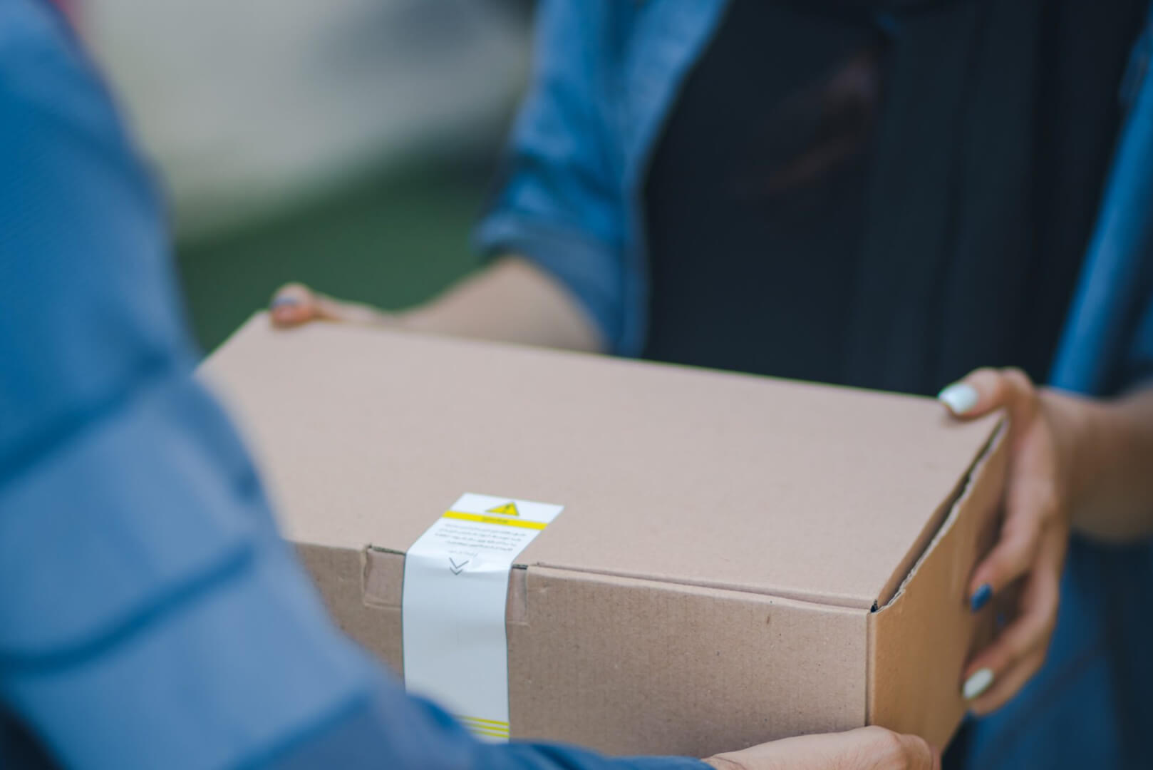 Image of a person handing over a box to another person