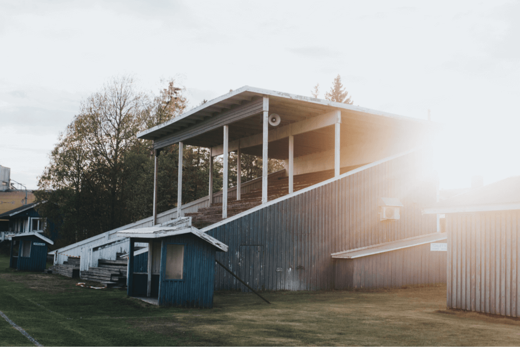 Image of a worn down, wooden seating section at a football field