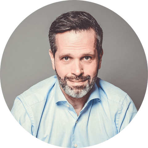 Image of a smilling man in a blue shirt