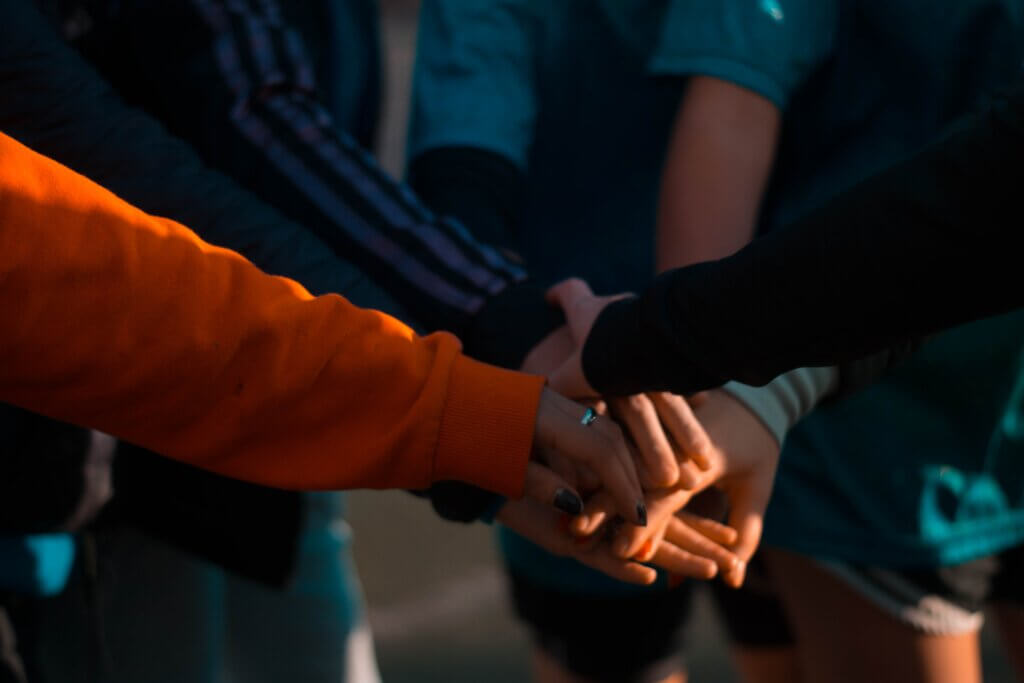 A group of women fist bumping